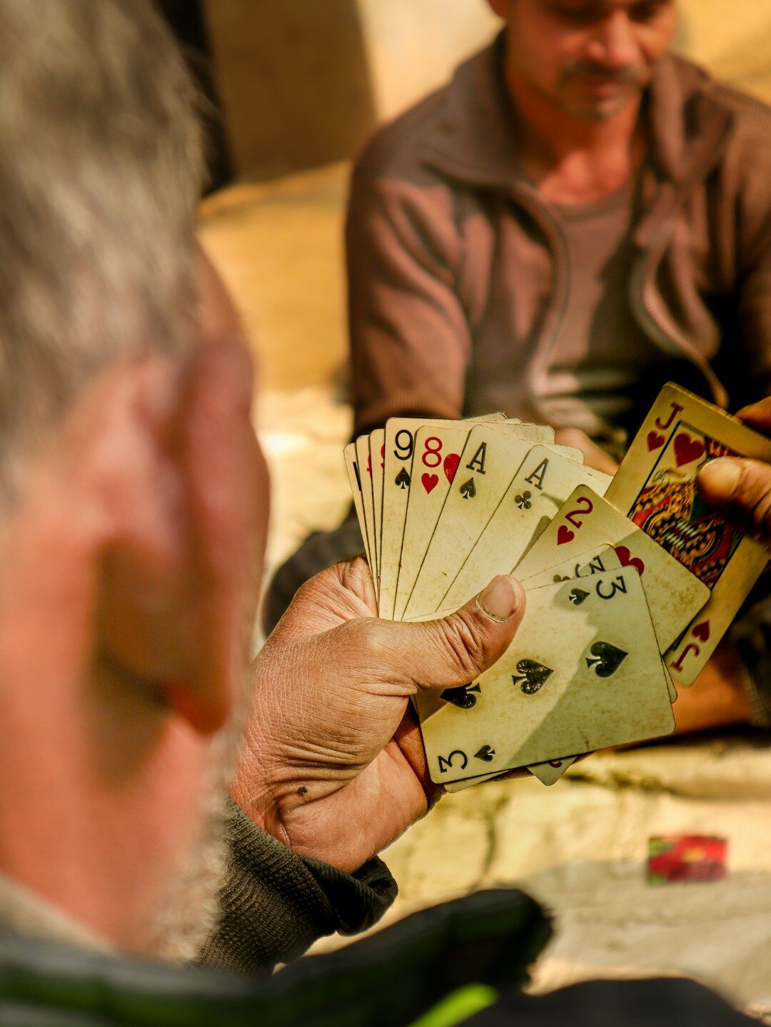 elderly people playing cards